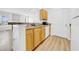 Practical kitchen layout with wood cabinetry and a view to the living area at 17996 Villa Creek Dr # 17996, Tampa, FL 33647