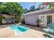 Relaxing backyard featuring a pool, patio seating, and lush landscaping, ideal for outdoor living and entertaining at 1822 1St Se St, St Petersburg, FL 33705