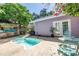 Relaxing backyard featuring a pool, patio seating, and lush landscaping, ideal for outdoor living and entertaining at 1822 1St Se St, St Petersburg, FL 33705