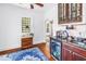 Stylish bar area with wood cabinets, granite countertops, and a mini fridge at 1822 1St Se St, St Petersburg, FL 33705