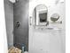 Bathroom featuring gray tiled walls, a shower, and an arched mirror at 1822 1St Se St, St Petersburg, FL 33705