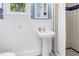 Charming bathroom featuring a pedestal sink, wainscoting, and classic black and white tile at 1822 1St Se St, St Petersburg, FL 33705