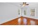 Empty bedroom with hardwood floors, white walls, and natural light from three windows at 1822 1St Se St, St Petersburg, FL 33705