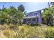 Two-story home with a screened-in porch surrounded by lush tropical plants and landscaping at 1822 1St Se St, St Petersburg, FL 33705