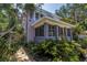 Two-story home with a screened-in porch surrounded by lush tropical plants and landscaping at 1822 1St Se St, St Petersburg, FL 33705