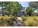 Landscaped front yard with a charming two-story home, lush foliage and inviting walkway at 1822 1St Se St, St Petersburg, FL 33705