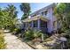 Quaint two-story home with a screened-in porch, complemented by lush landscaping at 1822 1St Se St, St Petersburg, FL 33705