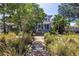 Landscaped front yard with a charming two-story home, lush foliage and inviting walkway at 1822 1St Se St, St Petersburg, FL 33705