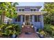 Charming home featuring a yellow screen door and vibrant potted plants flanking the steps at 1822 1St Se St, St Petersburg, FL 33705