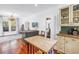Bright kitchen featuring hardwood floors, countertops, and cabinetry with glass doors at 1822 1St Se St, St Petersburg, FL 33705
