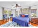 Bright main bedroom with hardwood floors, blue bedding, and multiple windows at 1822 1St Se St, St Petersburg, FL 33705