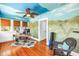 Bright home office with unique mural, hardwood floors, desk, and wicker chair for a creative and productive workspace at 1822 1St Se St, St Petersburg, FL 33705