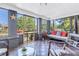 Relaxing screened porch features checkered tile flooring, comfortable seating, and views of lush landscaping at 1822 1St Se St, St Petersburg, FL 33705
