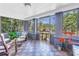 Comfortable screened porch with checkered floors features seating, offering a relaxing outdoor space at 1822 1St Se St, St Petersburg, FL 33705