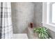 Modern shower with tiled walls, built-in seat, and natural light at 1822 1St Se St, St Petersburg, FL 33705
