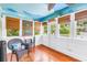 Cozy sunroom with vibrant decor, wood floors, and abundant natural light at 1822 1St Se St, St Petersburg, FL 33705