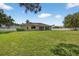 Large, grassy backyard offers ample space and features a screened-in patio for comfortable outdoor living at 1835 Fircrest Ct, Wesley Chapel, FL 33543