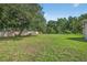 View of backyard showcasing expansive grassy lawn at 1835 Fircrest Ct, Wesley Chapel, FL 33543