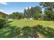 Spacious backyard with a lush lawn and privacy fence, offering a serene outdoor retreat at 1835 Fircrest Ct, Wesley Chapel, FL 33543