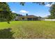 Expansive backyard featuring a well-maintained lawn and screened lanai, perfect for outdoor entertaining at 1835 Fircrest Ct, Wesley Chapel, FL 33543