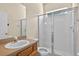 Bathroom featuring glass enclosed shower, toilet, sink with faucet, and a wooden cabinet underneath a mirror on the wall at 1835 Fircrest Ct, Wesley Chapel, FL 33543