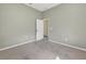 A bedroom featuring neutral colored walls, carpeted flooring, and a white door ajar revealing a glimpse into another room at 1835 Fircrest Ct, Wesley Chapel, FL 33543
