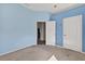 Bedroom features blue walls, neutral carpet, and two doors at 1835 Fircrest Ct, Wesley Chapel, FL 33543
