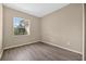 Neutral bedroom features wood-look flooring and a bright window at 1835 Fircrest Ct, Wesley Chapel, FL 33543