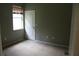 Cozy bedroom featuring a window and a door at 1835 Fircrest Ct, Wesley Chapel, FL 33543