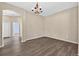 Dining room with wood floors and decorative chandelier at 1835 Fircrest Ct, Wesley Chapel, FL 33543