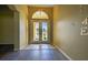 Bright foyer with double doors, tile floor transition, and views to exterior at 1835 Fircrest Ct, Wesley Chapel, FL 33543