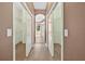 Hallway view with walk-in closets on either side, providing ample storage at 1835 Fircrest Ct, Wesley Chapel, FL 33543