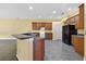 Kitchen with black appliances, breakfast bar and ample wooden cabinets at 1835 Fircrest Ct, Wesley Chapel, FL 33543