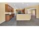 Spacious kitchen with dark wood cabinets, dark countertops, and large breakfast bar at 1835 Fircrest Ct, Wesley Chapel, FL 33543