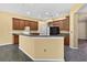 Open kitchen with dark wood cabinetry, granite countertops, and a breakfast bar peninsula at 1835 Fircrest Ct, Wesley Chapel, FL 33543