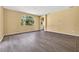 Bright living area showcasing wood floors, arched window, and neutral wall color at 1835 Fircrest Ct, Wesley Chapel, FL 33543