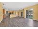 Open-concept living area with wood floors, sliding glass doors, and ample natural light at 1835 Fircrest Ct, Wesley Chapel, FL 33543