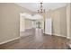Open concept living room with wood floors and sliding glass doors at 1835 Fircrest Ct, Wesley Chapel, FL 33543