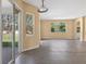 Bright living room with wood-look floors and large windows overlooking the backyard at 1835 Fircrest Ct, Wesley Chapel, FL 33543