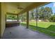 Screened in patio featuring a hot tub, ceiling fan, and views of the backyard at 1835 Fircrest Ct, Wesley Chapel, FL 33543