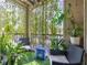Outdoor balcony with plants, hanging lights, faux grass, and furniture at 18439 Bridle Club Dr # 18439, Tampa, FL 33647