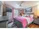 Cozy bedroom featuring a plush pink comforter, gray wood furnishings, and a ceiling fan for added comfort at 18439 Bridle Club Dr # 18439, Tampa, FL 33647