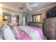 Bright bedroom showcasing a pink comforter and gray wood furniture, with a ceiling fan to keep you cool at 18439 Bridle Club Dr # 18439, Tampa, FL 33647