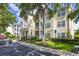 Three-story condo building with balconies, green shrubs, and a parking lot in front at 18439 Bridle Club Dr # 18439, Tampa, FL 33647