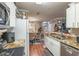 Open kitchen view leading to dining area, featuring stainless appliances and granite countertops at 18439 Bridle Club Dr # 18439, Tampa, FL 33647