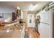 Bright kitchen with white cabinets, granite countertops, stainless steel appliances, and wood flooring at 18439 Bridle Club Dr # 18439, Tampa, FL 33647
