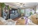Cozy living room with a large TV, shelving unit, ceiling fan, and comfortable seating at 18439 Bridle Club Dr # 18439, Tampa, FL 33647