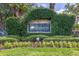 Equestrian Parc neighborhood sign surrounded by lush greenery and colorful flowers, showcasing community pride at 18439 Bridle Club Dr # 18439, Tampa, FL 33647