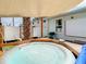 A backyard with a hot tub, outdoor seating, and a projector screen for entertainment at 1887 Springtime Ave, Clearwater, FL 33755