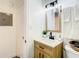 Bright bathroom featuring a modern vanity with wood-look cabinetry and stylish mirror at 1887 Springtime Ave, Clearwater, FL 33755